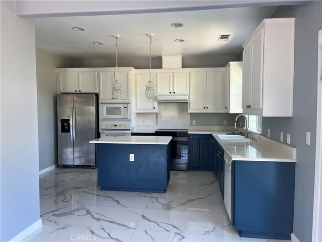 kitchen featuring a sink, white appliances, baseboards, under cabinet range hood, and recessed lighting