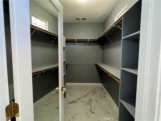 spacious closet with visible vents and marble finish floor