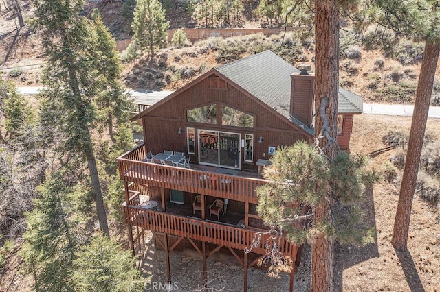 exterior space featuring a chimney and a wooden deck