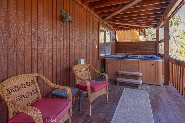 exterior space featuring a wooden deck and a hot tub