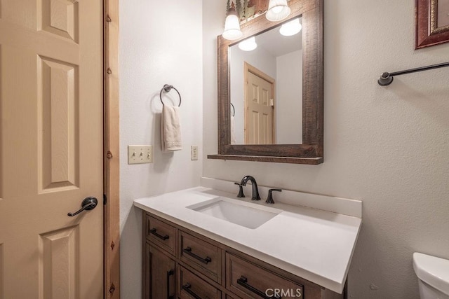 half bathroom with vanity and toilet