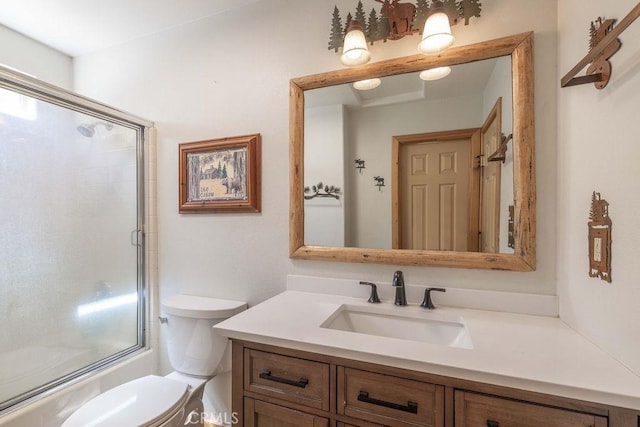 full bath with vanity, a shower with shower door, and toilet