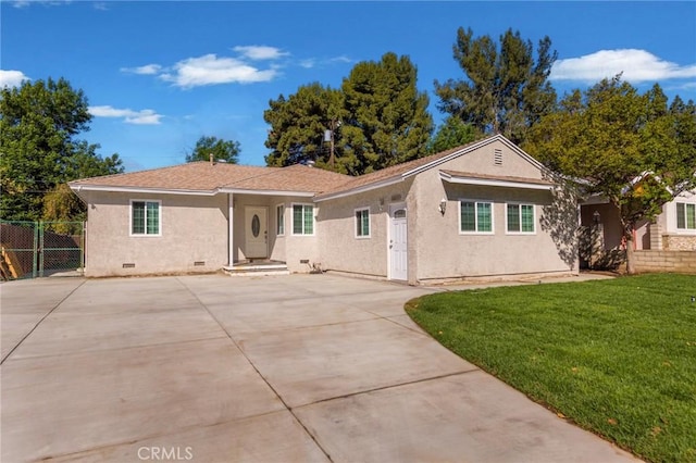 single story home featuring crawl space, concrete driveway, fence, a front yard, and stucco siding
