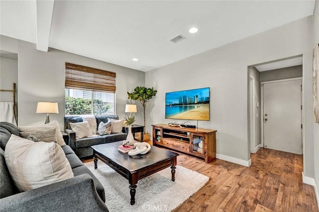 living area with baseboards, recessed lighting, light wood-style floors, and visible vents