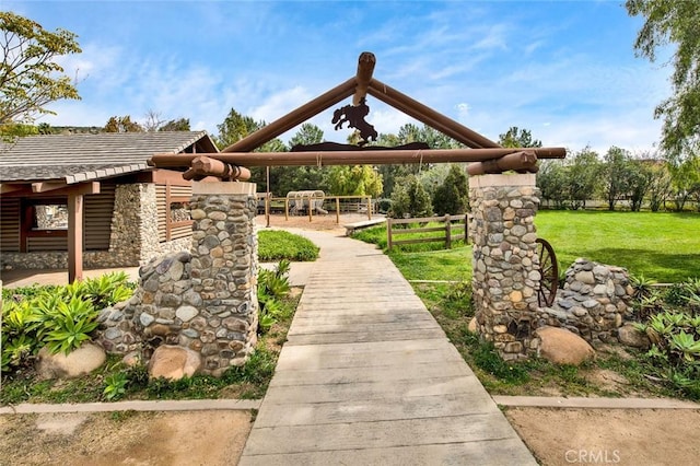 surrounding community with fence and a yard