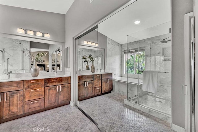 bathroom with recessed lighting, double vanity, a sink, and a shower stall