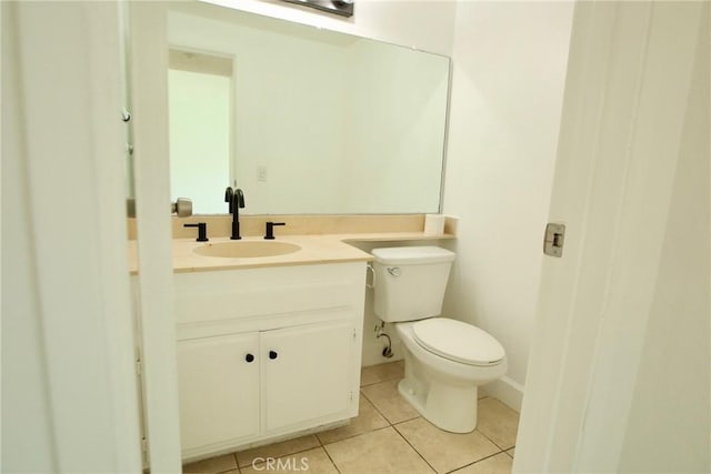half bathroom with vanity, toilet, and tile patterned flooring