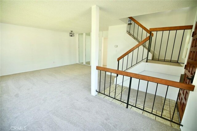stairs featuring carpet floors