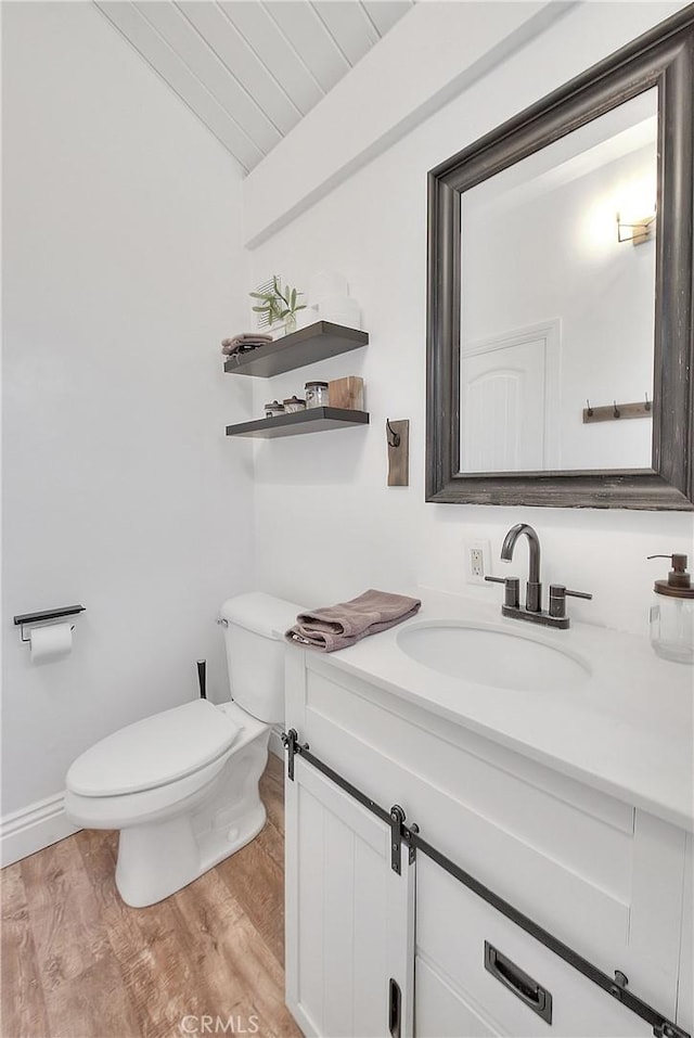 346 San Bernardino Ave, Sugarloaf, CA 92386 - half bathroom with vaulted ceiling, wood finished floors, vanity, and toilet