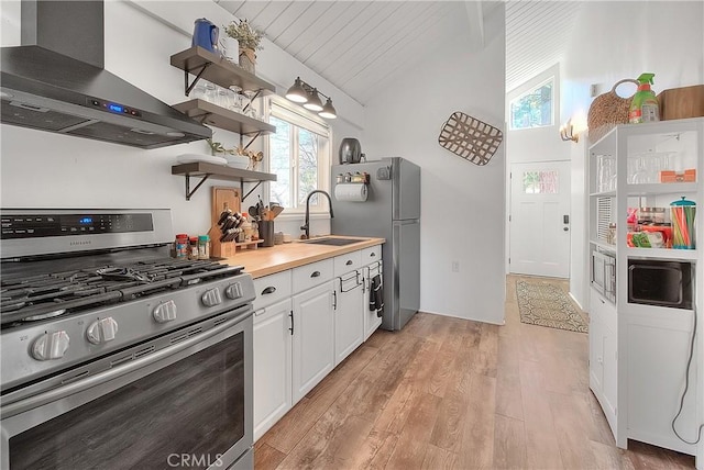 346 San Bernardino Ave, Sugarloaf, CA 92386 - kitchen featuring a sink, lofted ceiling, light wood-style flooring, wall chimney exhaust hood, and appliances with stainless steel finishes