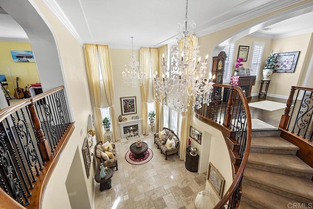 2831 Shenandoah Dr, Chula Vista, CA 91914 - stairs with arched walkways, a chandelier, a large fireplace, crown molding, and a high ceiling
