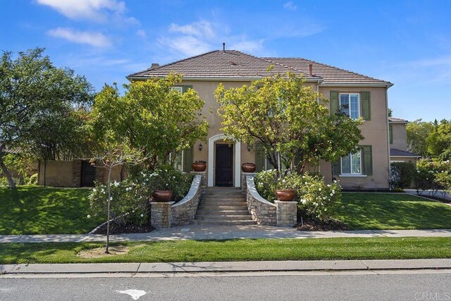 2831 Shenandoah Dr, Chula Vista, CA 91914 - view of property hidden behind natural elements featuring a front lawn, stucco siding, and a tiled roof