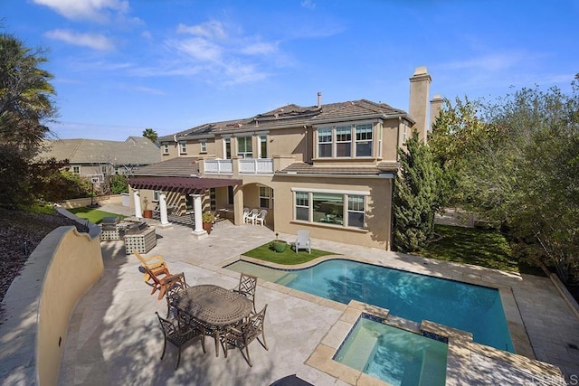 2831 Shenandoah Dr, Chula Vista, CA 91914 - back of property featuring a balcony, a patio, stucco siding, a chimney, and outdoor dining area