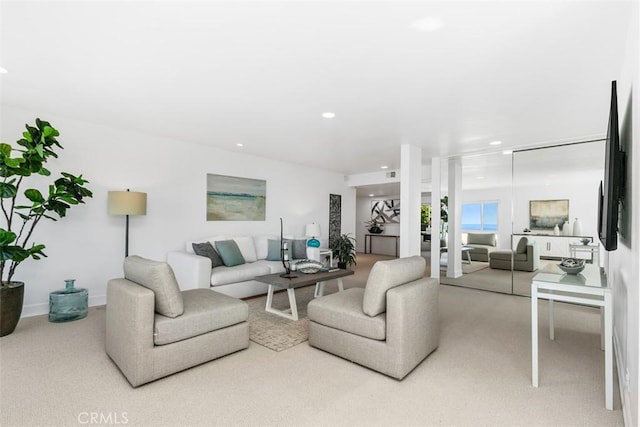 carpeted living area with recessed lighting