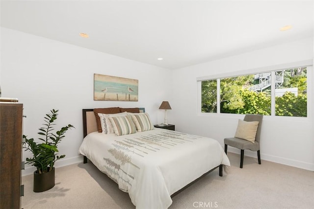 bedroom with baseboards, recessed lighting, and light colored carpet