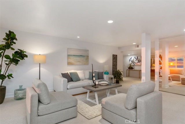living area with baseboards, visible vents, recessed lighting, and light colored carpet