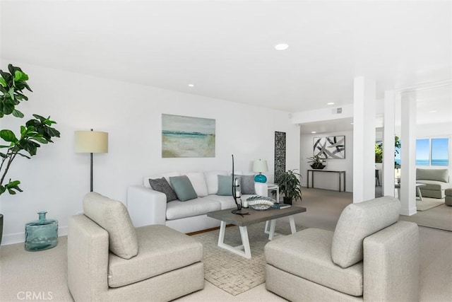 living room with carpet flooring, visible vents, and recessed lighting