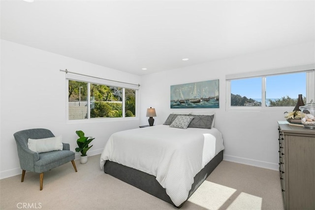 bedroom with baseboards, carpet flooring, and multiple windows