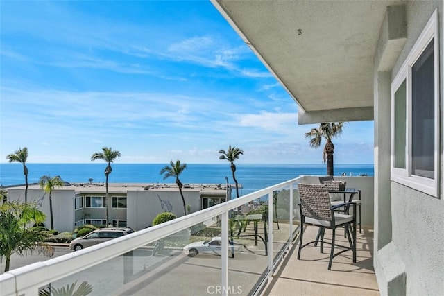 balcony featuring a water view
