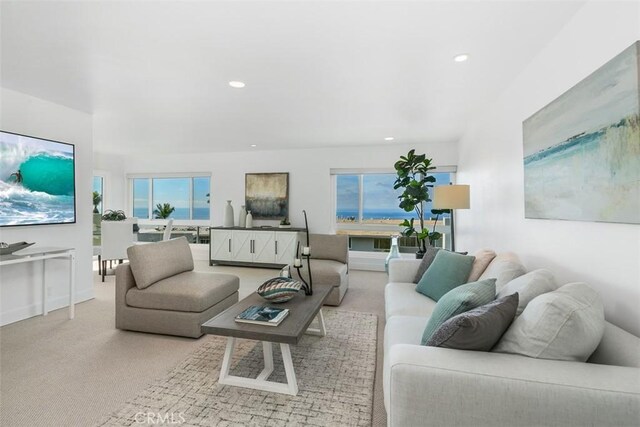 living room featuring baseboards, carpet flooring, and recessed lighting