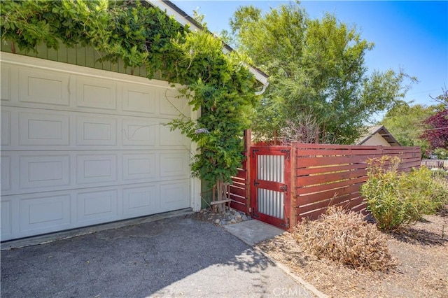 8920 Arcade Rd, Atascadero, CA 93422 - garage featuring a gate and asphalt driveway