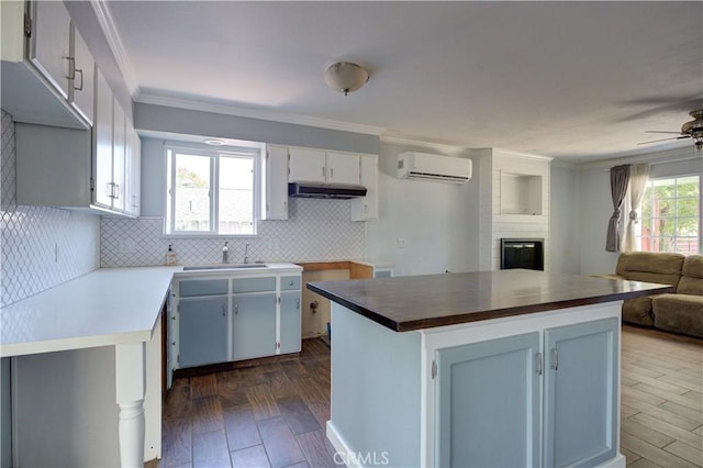 8920 Arcade Rd, Atascadero, CA 93422 - kitchen featuring a wall unit AC, range hood, open floor plan, ceiling fan, and tasteful backsplash