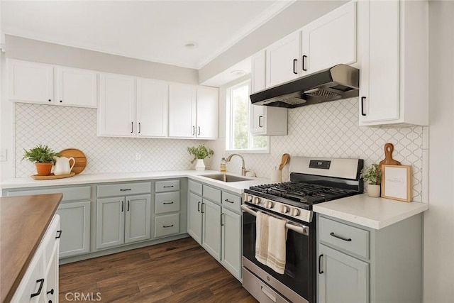 8920 Arcade Rd, Atascadero, CA 93422 - kitchen featuring stainless steel gas range, under cabinet range hood, backsplash, dark wood-type flooring, and white cabinetry