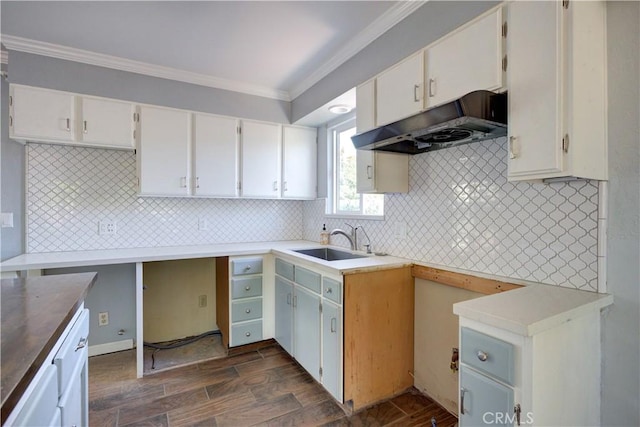 8920 Arcade Rd, Atascadero, CA 93422 - kitchen featuring under cabinet range hood, crown molding, decorative backsplash, dark wood-style floors, and white cabinets