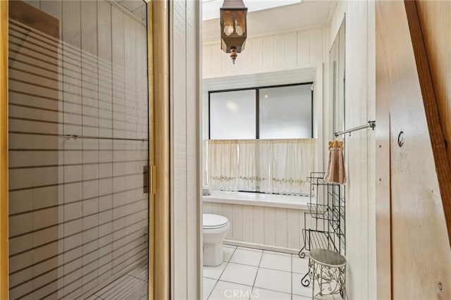 full bath with a bath, tile patterned floors, a shower stall, and toilet