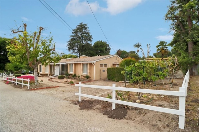 single story home featuring fence