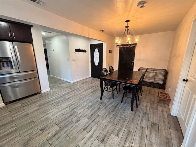 35132 Ave C, Yucaipa, CA 92399 - dining room with wood finished floors, a chandelier, and baseboards