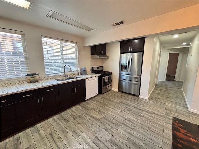 35132 Ave C, Yucaipa, CA 92399 - kitchen with stainless steel appliances, a sink, light wood-style floors, under cabinet range hood, and light stone countertops