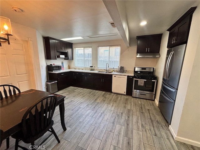 35132 Ave C, Yucaipa, CA 92399 - kitchen with appliances with stainless steel finishes, light wood-style flooring, light countertops, a sink, and beamed ceiling