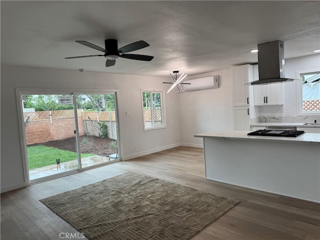 1333 Lancewood Ave, Hacienda Heights, CA 91745 - kitchen with island exhaust hood, white cabinetry, black stovetop, and light wood-style flooring