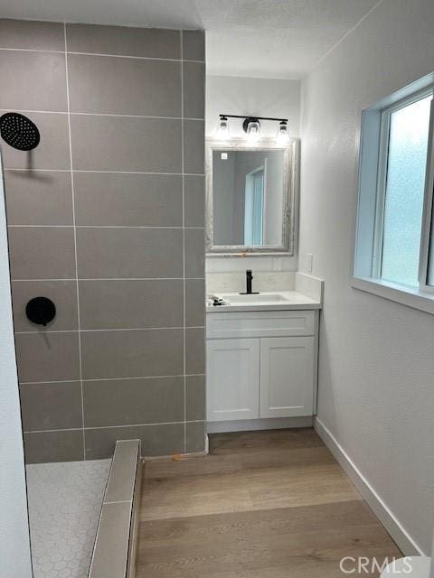 1333 Lancewood Ave, Hacienda Heights, CA 91745 - bathroom featuring wood finished floors, vanity, tiled shower, and baseboards