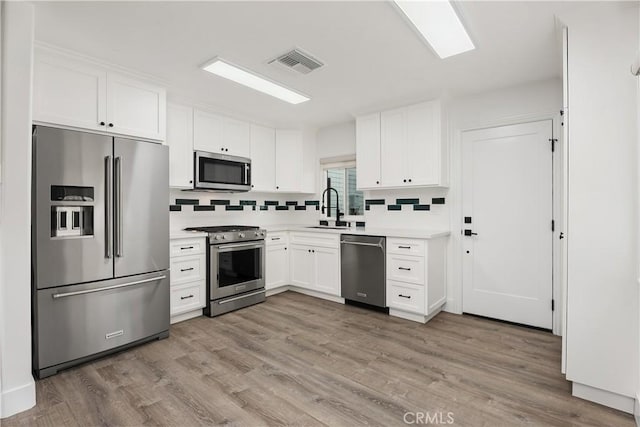 6130 Myrtle Ave, Long Beach, CA 90805 - kitchen with white cabinets, appliances with stainless steel finishes, a sink, and visible vents
