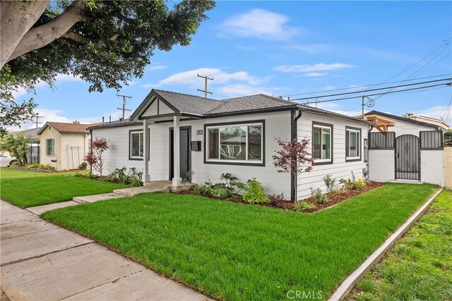 6130 Myrtle Ave, Long Beach, CA 90805 - view of front of home with a gate and a front lawn