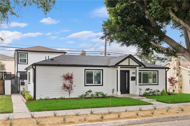 6130 Myrtle Ave, Long Beach, CA 90805 - single story home with a gate, roof with shingles, and a front lawn