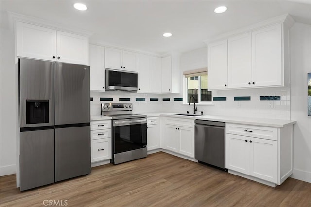 6130 Myrtle Ave, Long Beach, CA 90805 - kitchen with a sink, appliances with stainless steel finishes, tasteful backsplash, and white cabinetry