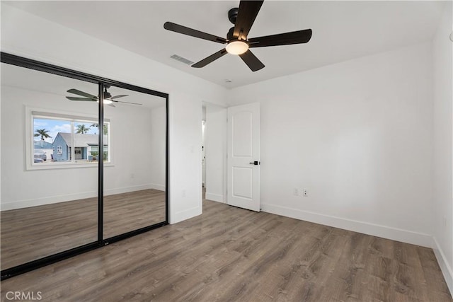 6130 Myrtle Ave, Long Beach, CA 90805 - unfurnished bedroom with baseboards, visible vents, wood finished floors, and a closet