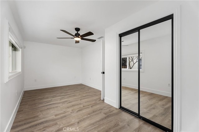 6130 Myrtle Ave, Long Beach, CA 90805 - unfurnished bedroom featuring baseboards, a ceiling fan, a closet, and wood finished floors