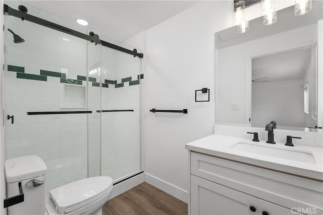 6130 Myrtle Ave, Long Beach, CA 90805 - bathroom featuring vanity, a shower stall, toilet, and wood finished floors