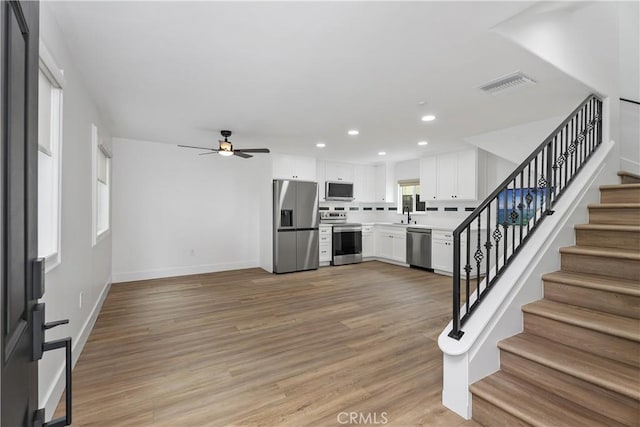 6130 Myrtle Ave, Long Beach, CA 90805 - unfurnished living room featuring ceiling fan, visible vents, stairway, baseboards, and recessed lighting