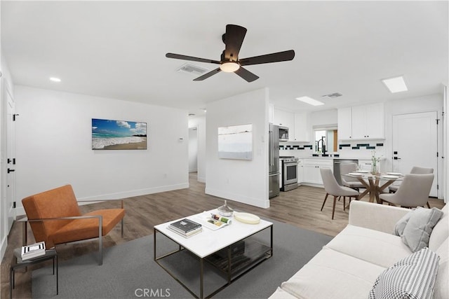 6130 Myrtle Ave, Long Beach, CA 90805 - living area with visible vents, light wood-style floors, baseboards, ceiling fan, and recessed lighting