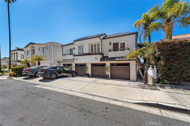 309 Carnation Ave Unit 4, Corona Del Mar, CA 92625 - townhome / multi-family property with a standing seam roof, stucco siding, a metal roof, an attached garage, and a residential view