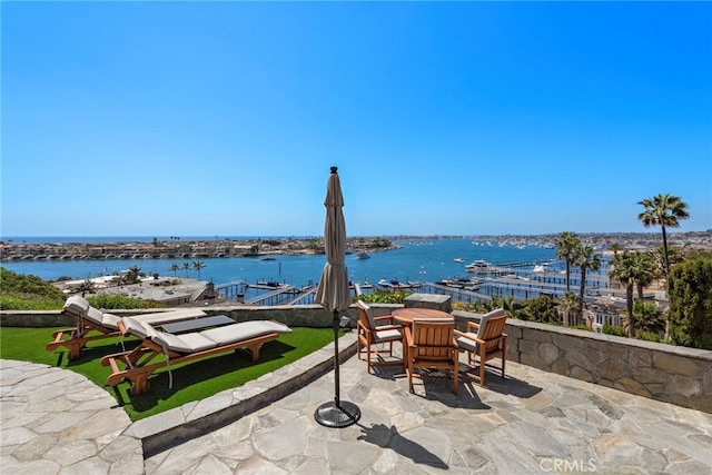 309 Carnation Ave Unit 4, Corona Del Mar, CA 92625 - view of patio / terrace with a water view, outdoor dining area, and a boat dock