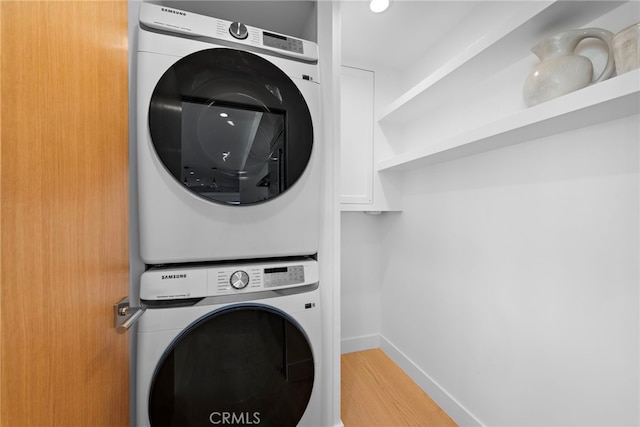 309 Carnation Ave Unit 4, Corona Del Mar, CA 92625 - washroom featuring stacked washer and clothes dryer and wood finished floors