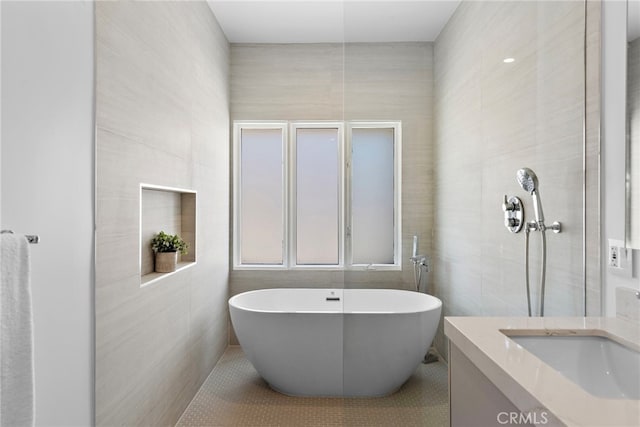 309 Carnation Ave Unit 4, Corona Del Mar, CA 92625 - full bathroom with tile walls, a soaking tub, tile patterned flooring, and vanity