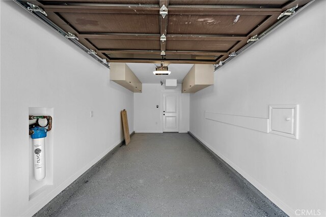 309 Carnation Ave Unit 4, Corona Del Mar, CA 92625 - garage featuring a garage door opener and baseboards