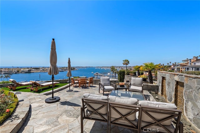 309 Carnation Ave Unit 4, Corona Del Mar, CA 92625 - view of patio featuring an outdoor living space, a water view, and outdoor dining area
